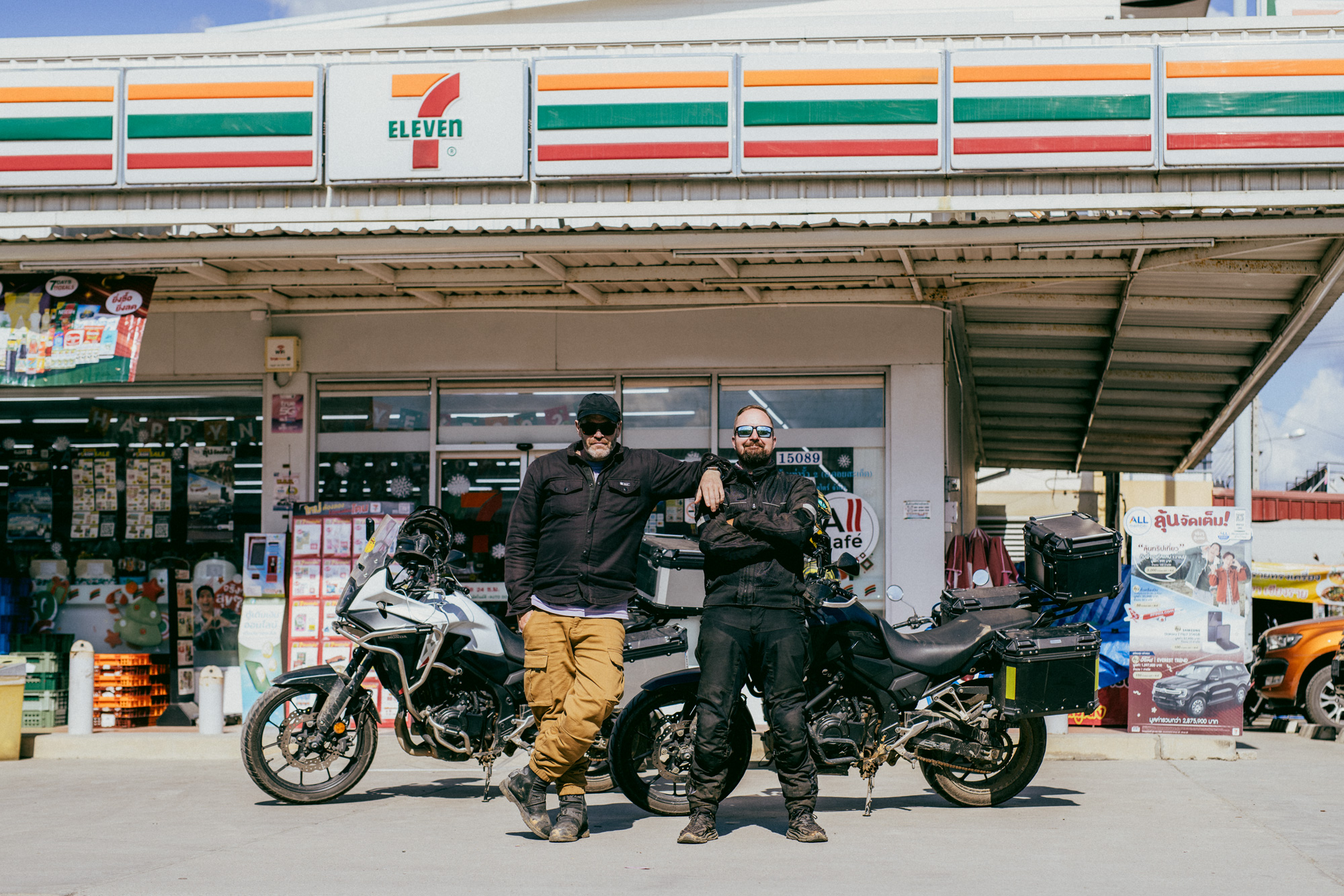 Two riders leaning on their bikes
