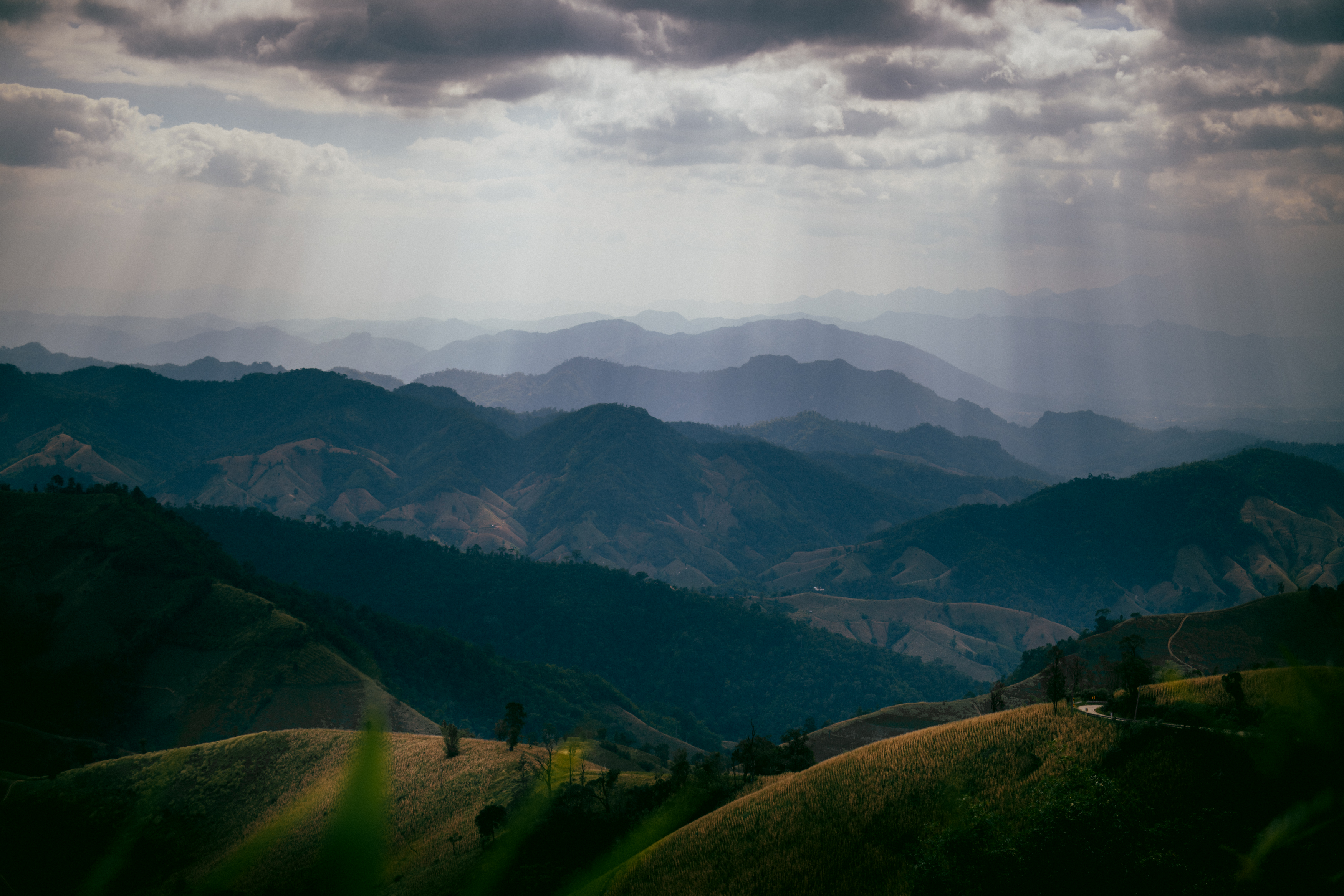 Layered mountain ridges in dim afternoon light