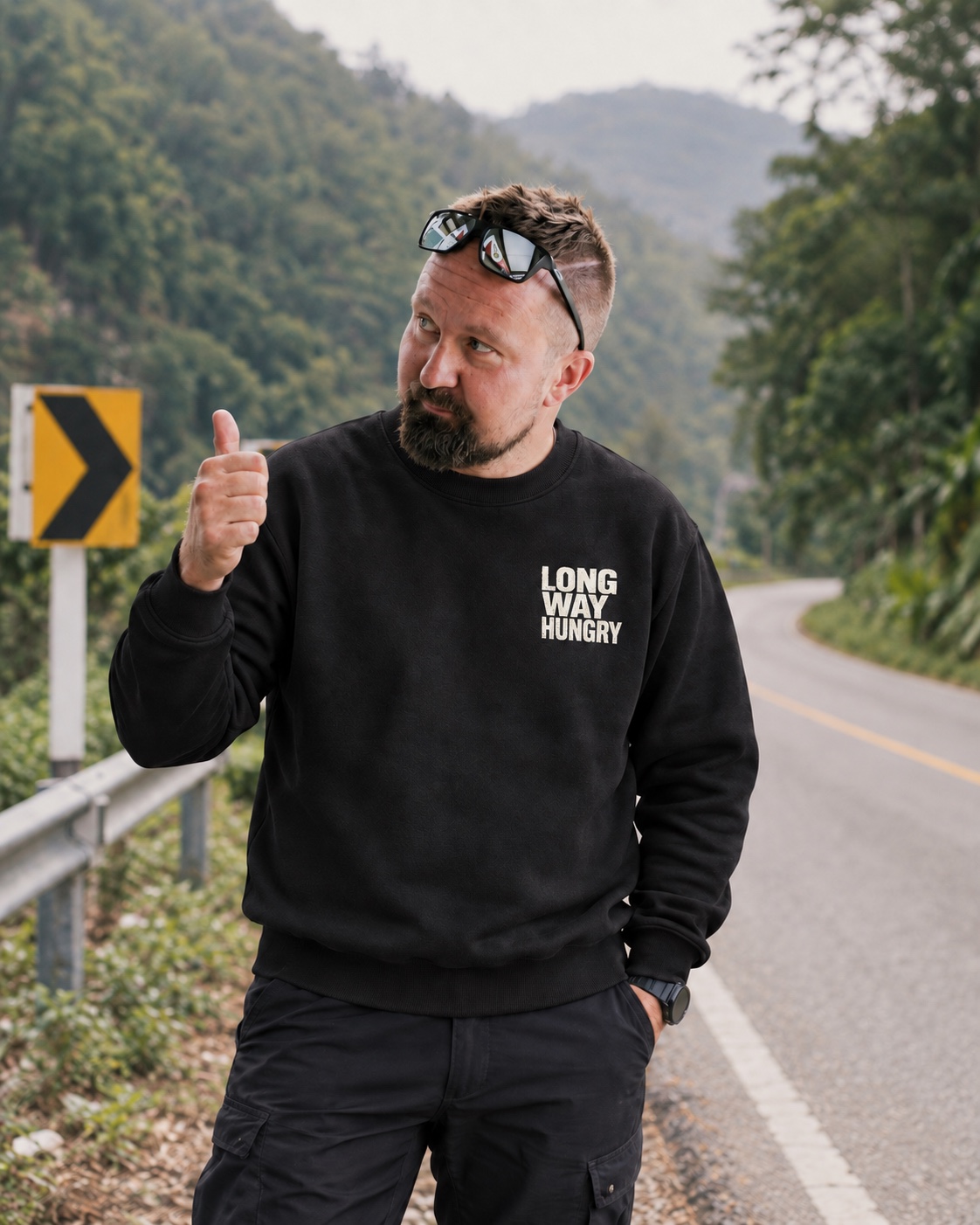 Matti, 172 cm tall, wearing a size M black sweatshirt with an approximately 10 cm white Long Way Hungry chest logo